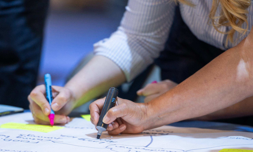 Photograph of people drawing with pens